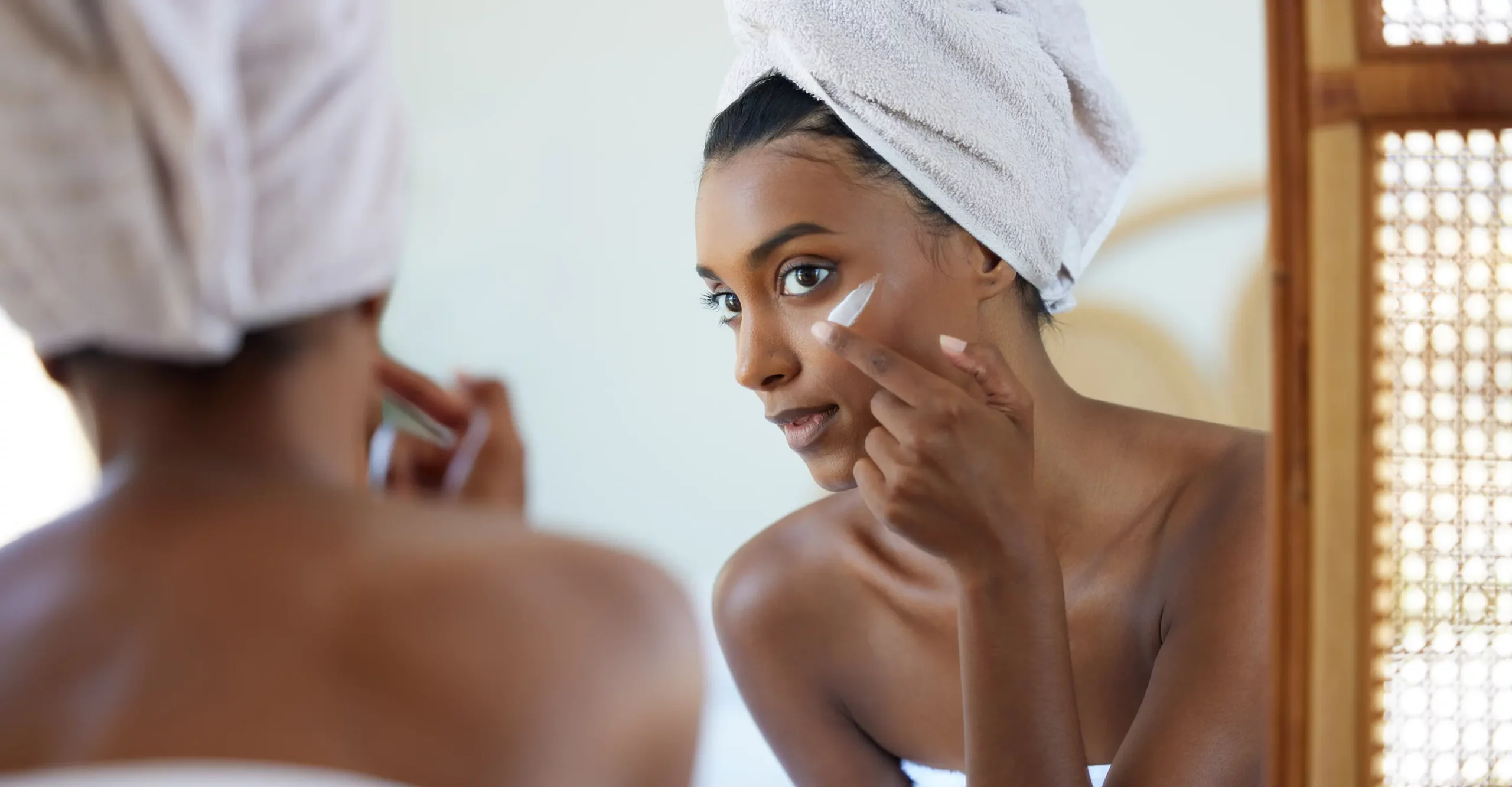 Woman applying exfoliating skin care with a combination of AHA and BHAs.