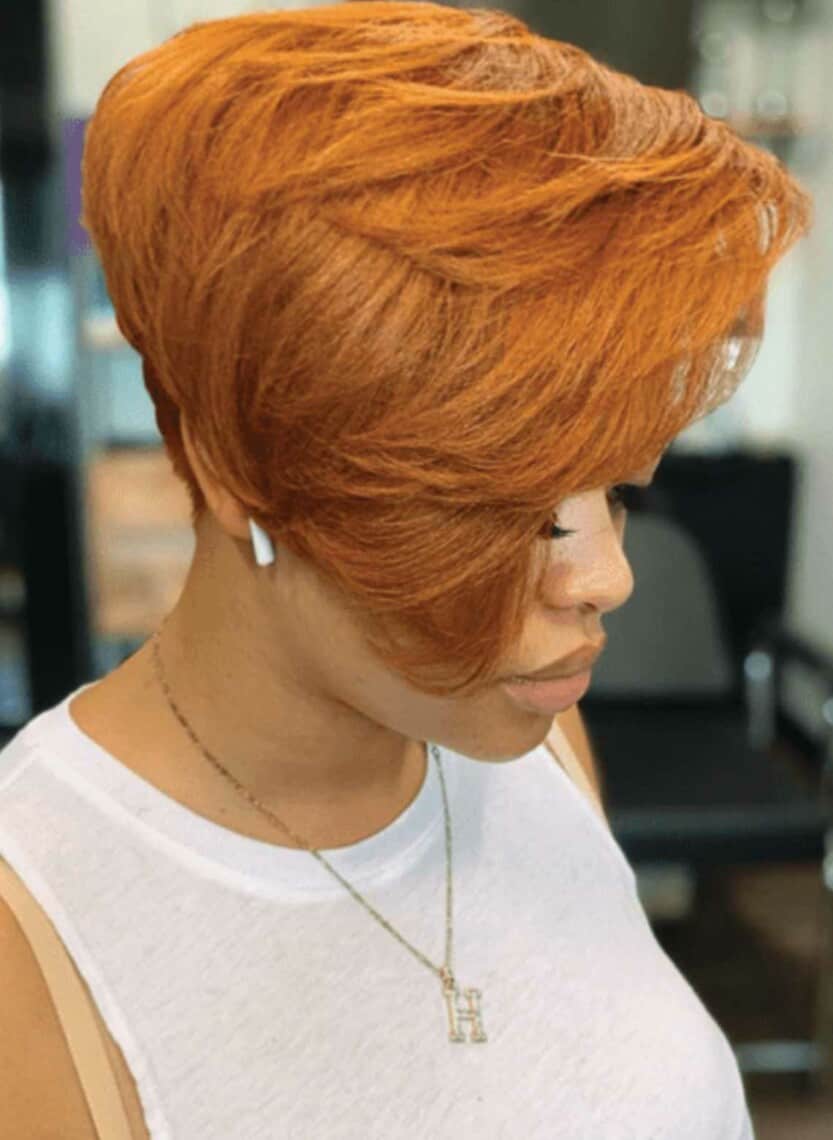 person looking down showing off copper-colored hair with layers