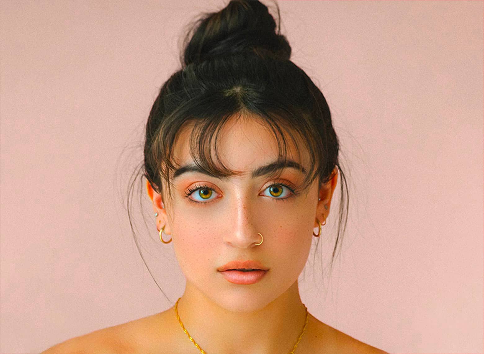 woman with top knot and bangs