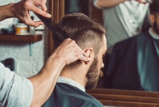 man getting haircut at a barber shop