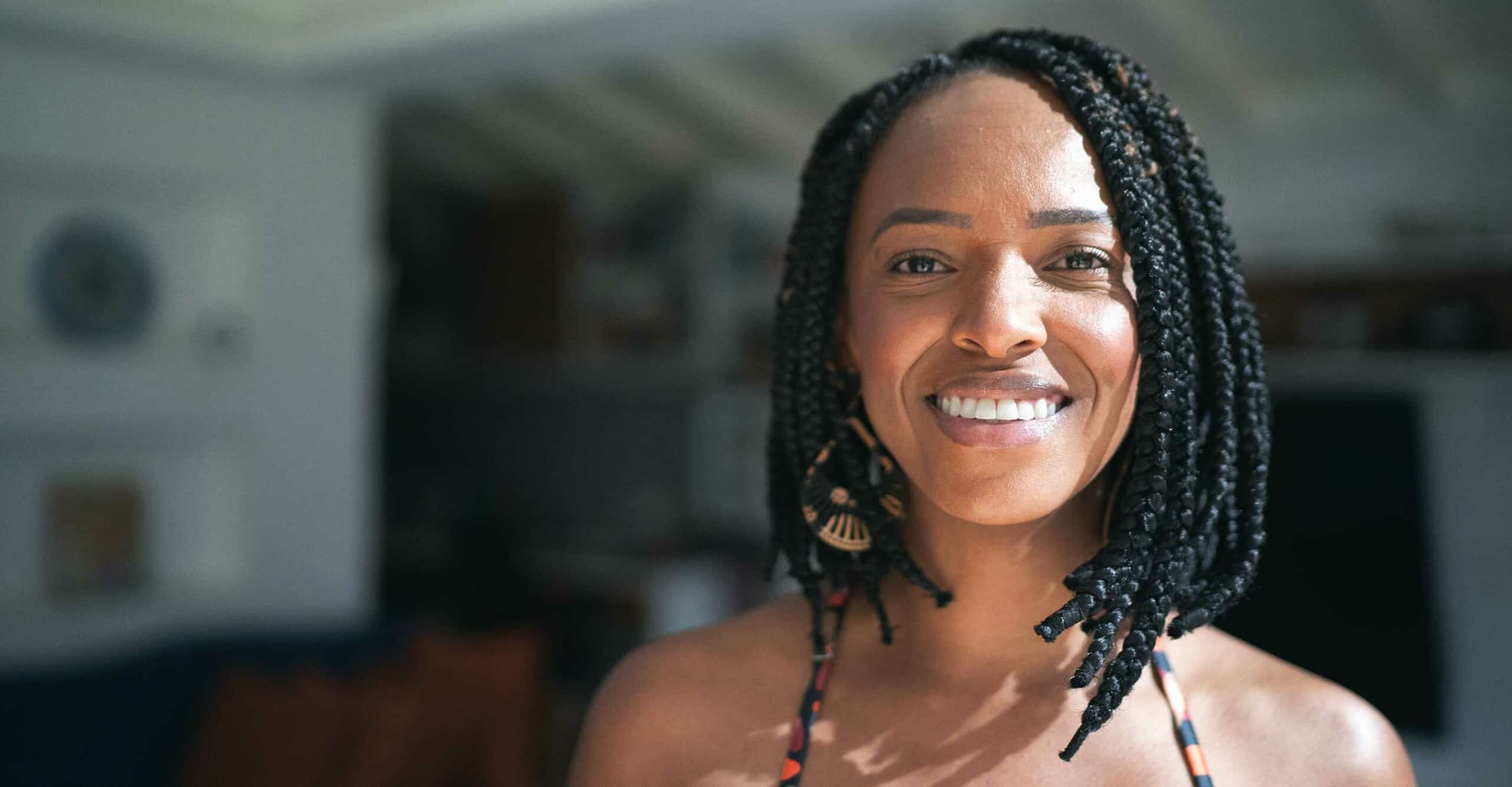 woman smiling with braided shoulder length hair