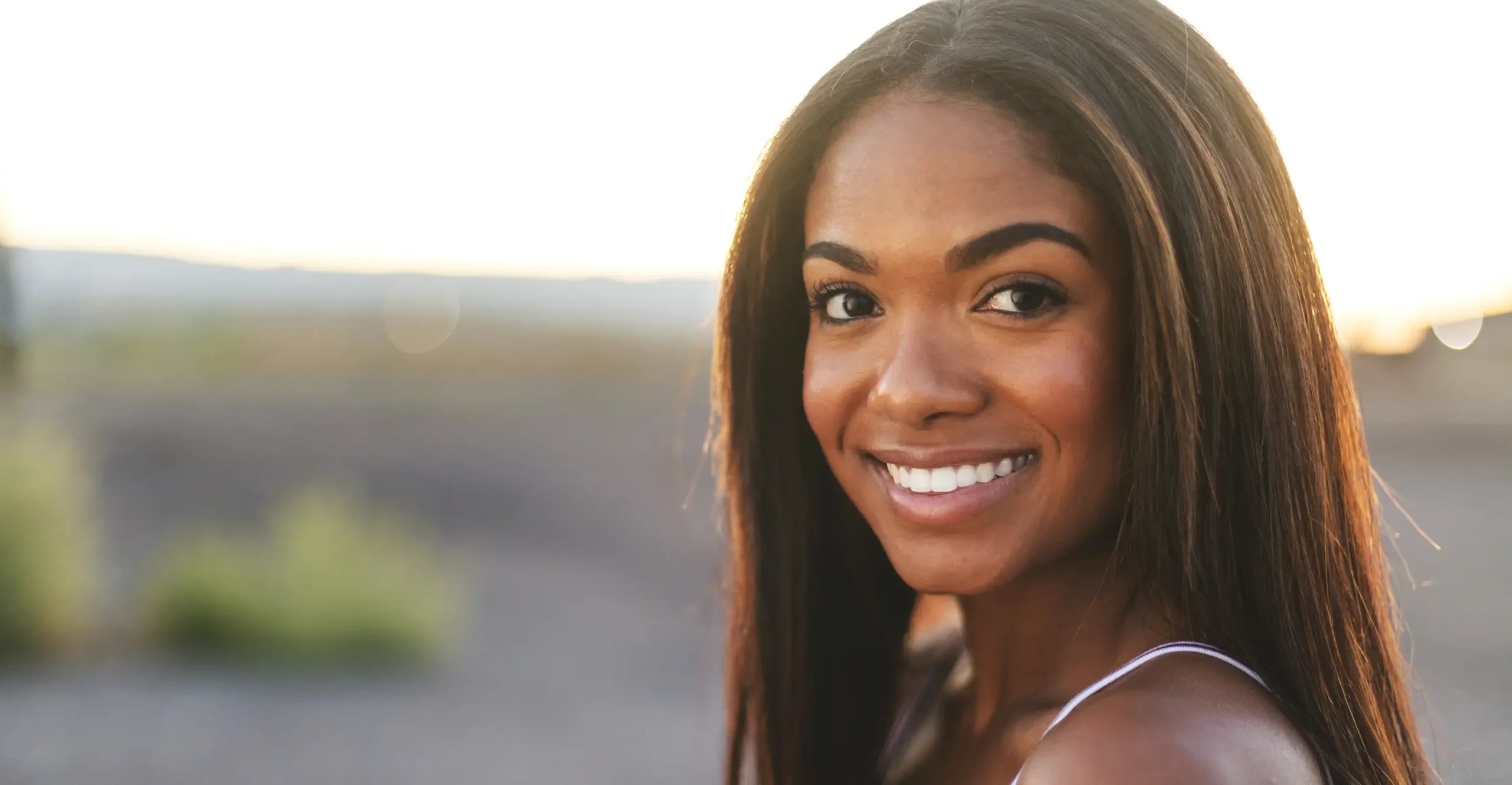 Woman smiling with her new hair extensions.