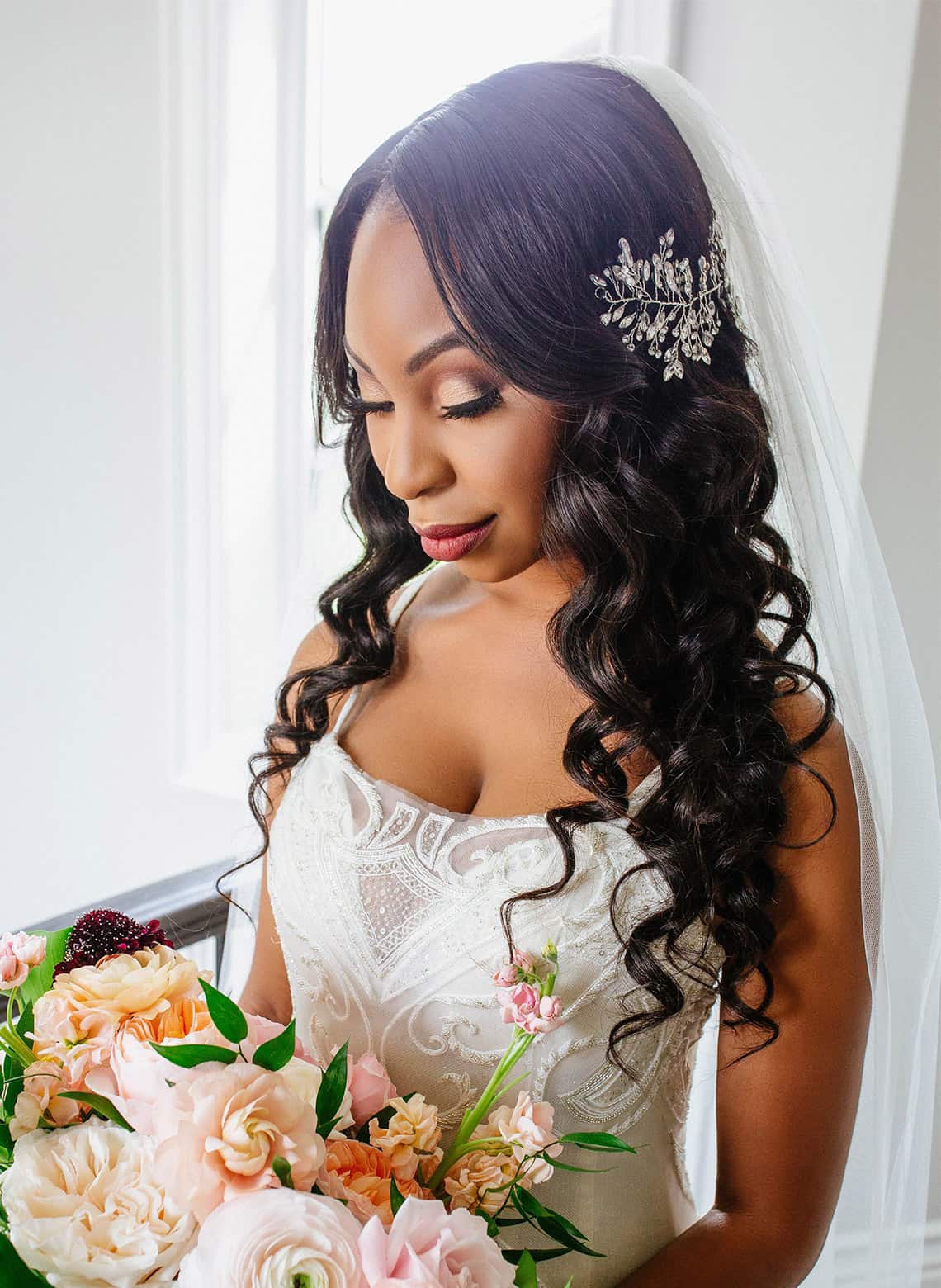 bride with long curls and accent jewel clip