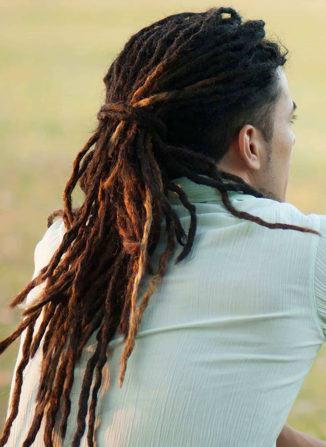man with low ponytail dreads