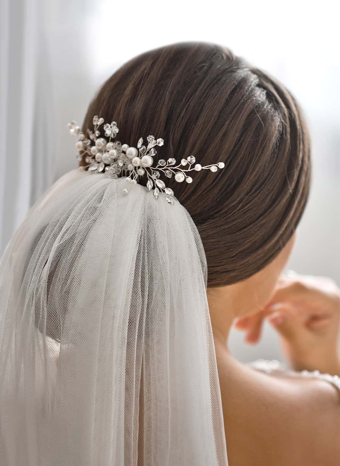 bride with rolled updo and veil