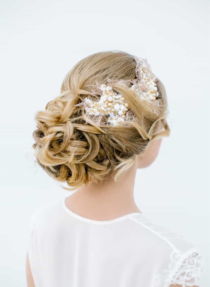 bride with weave through updo and headpiece