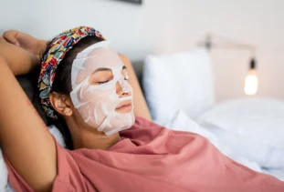 Woman lounges with an at-home facial.
