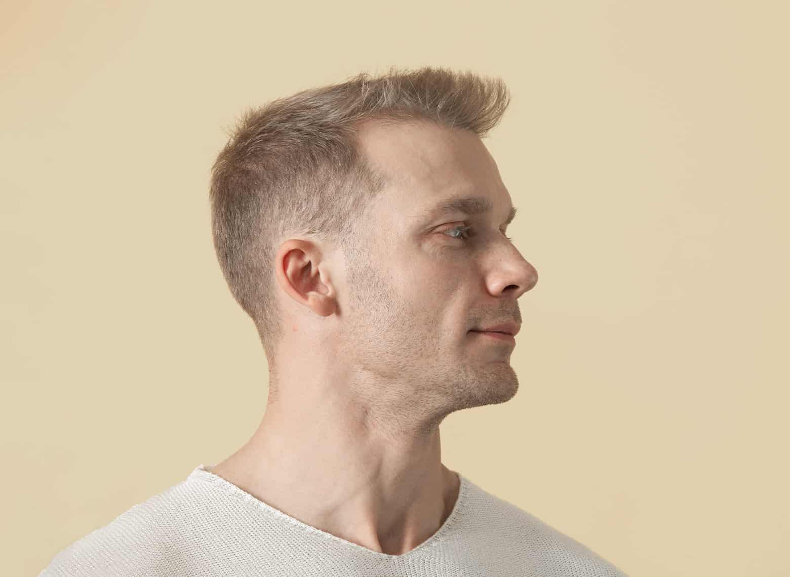 man with short hair and low taper