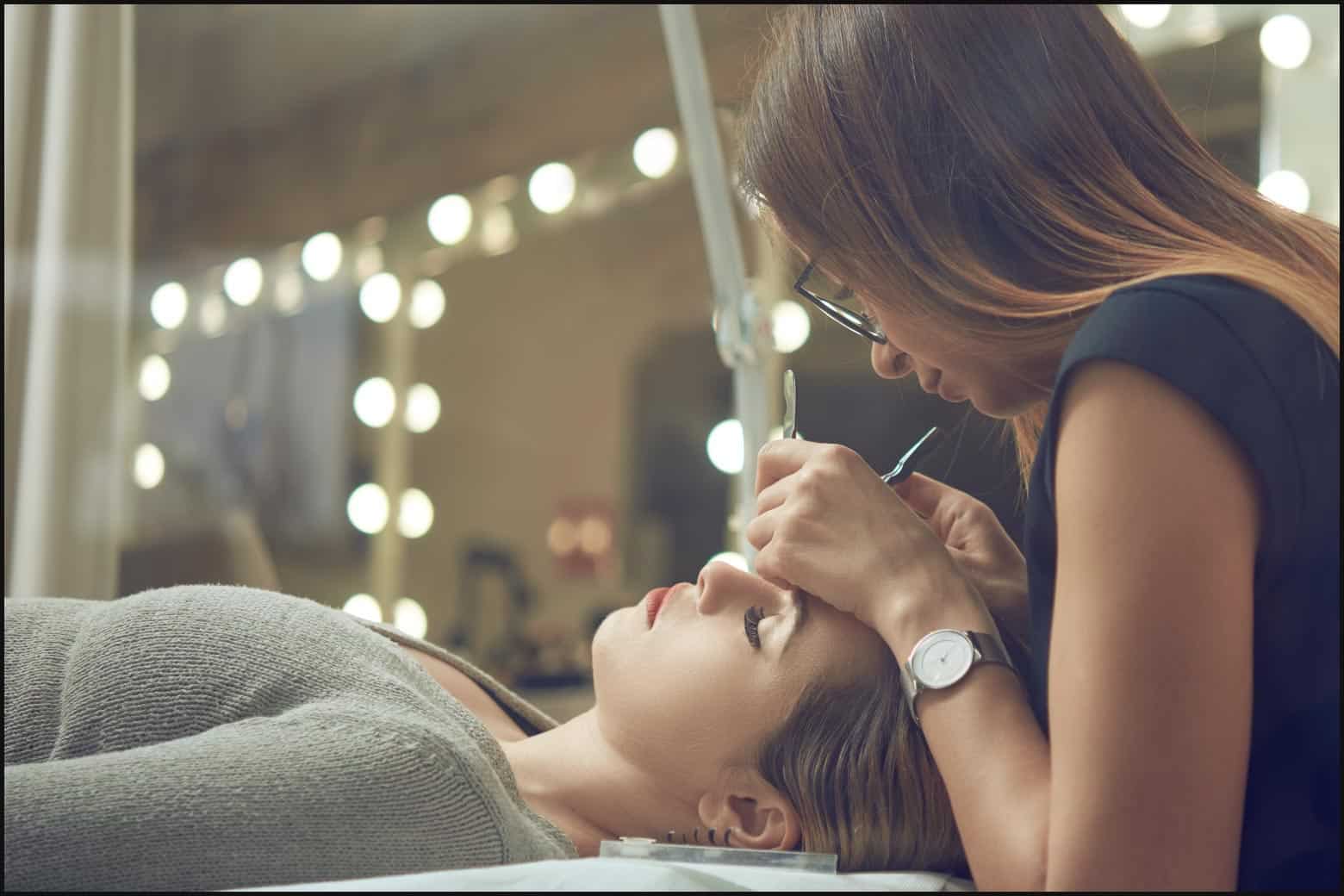 person applying lash extensions at the salon