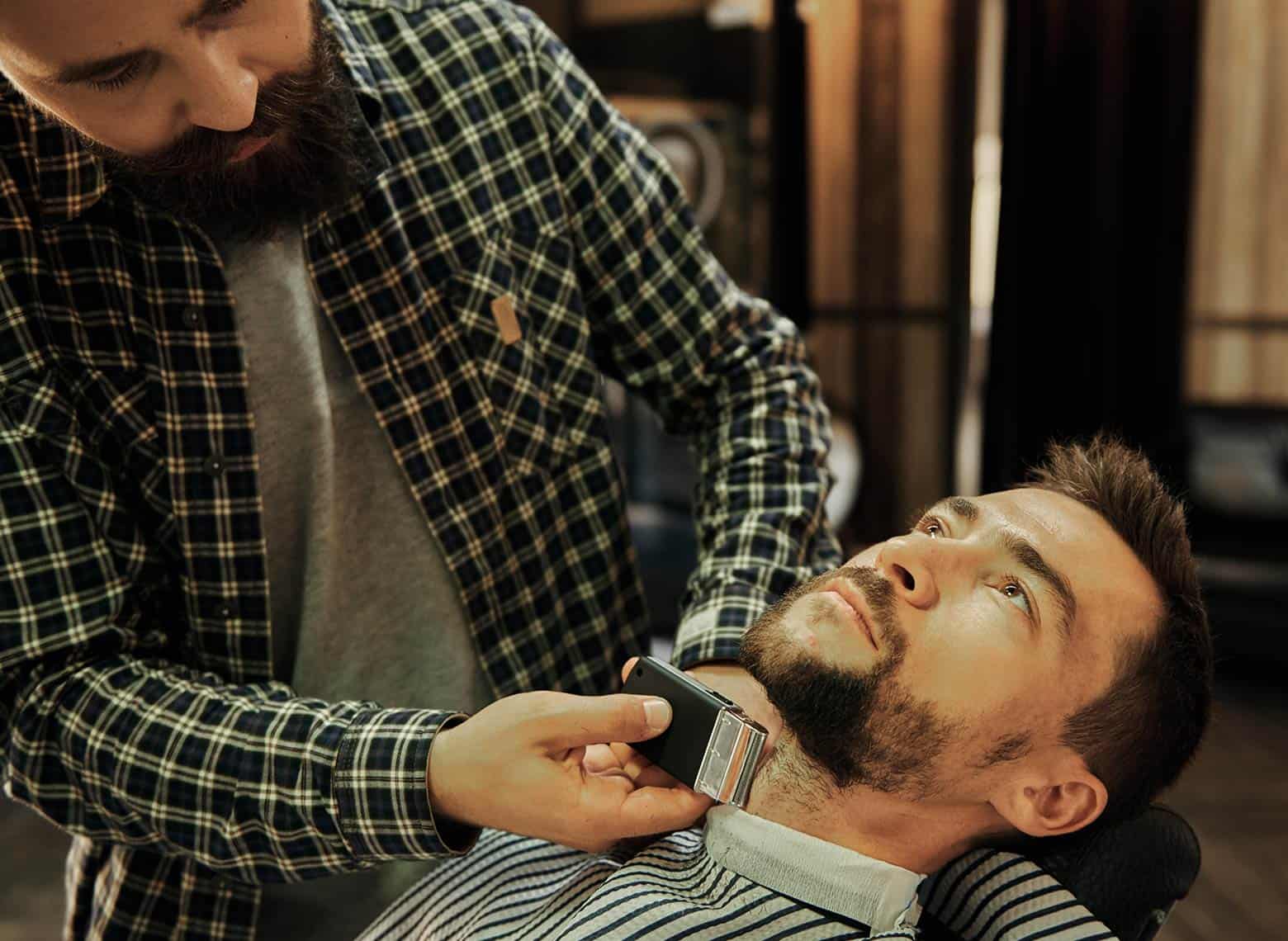 man in barber chair getting shave
