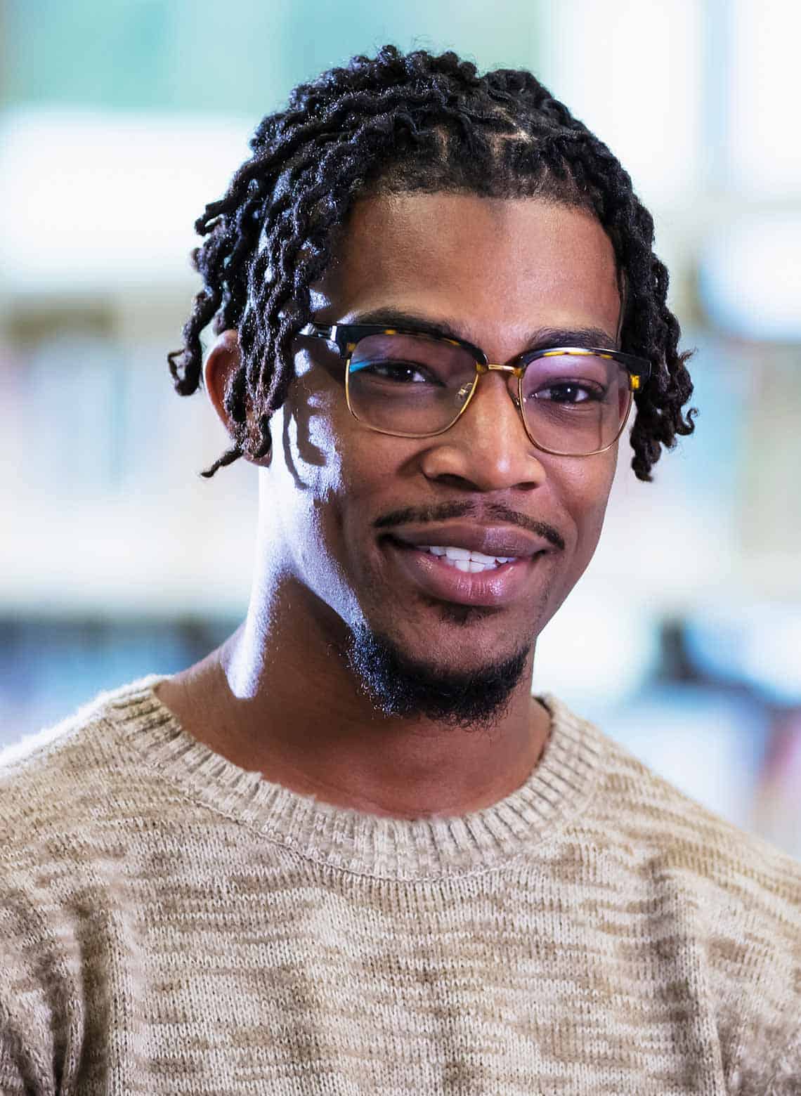 man with loose curly locs