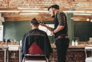 person getting haircut at a barbershop