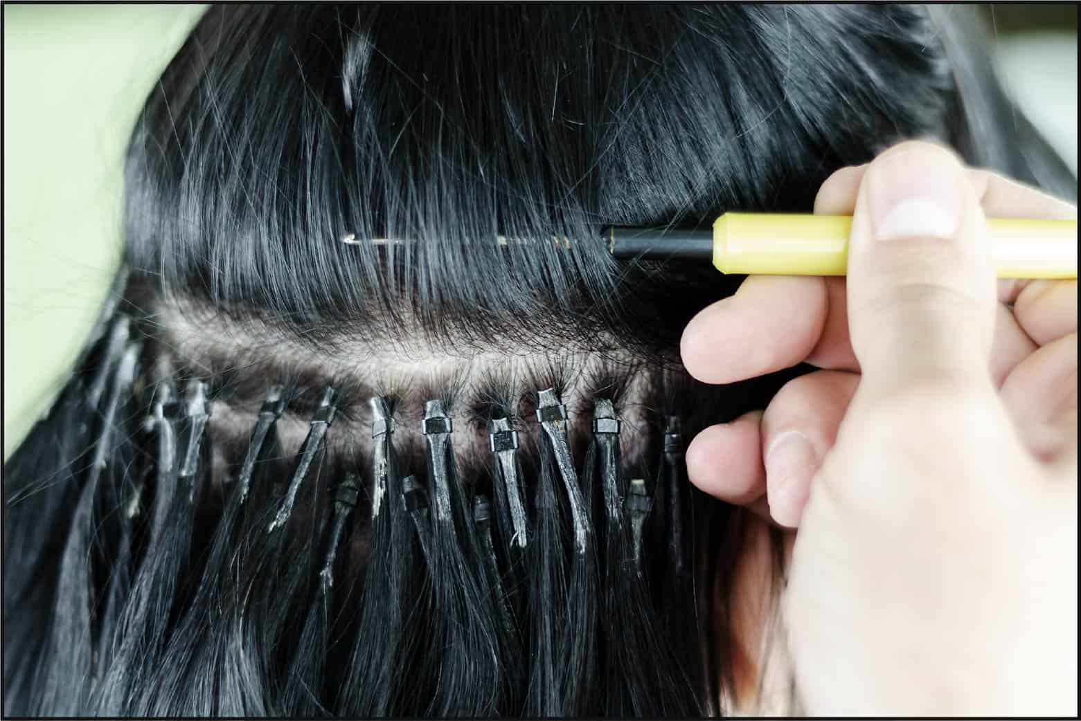 stylist applying microlink hair extensions