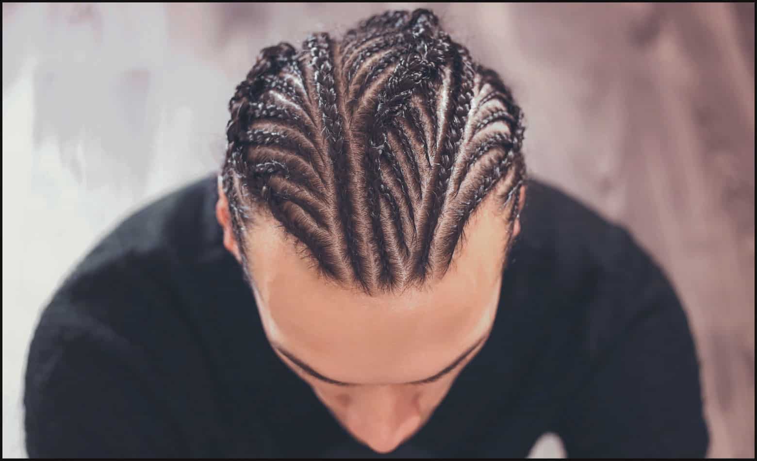 top view of intricate cornrow design on person wearing black shirt