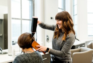woman styling client's hair