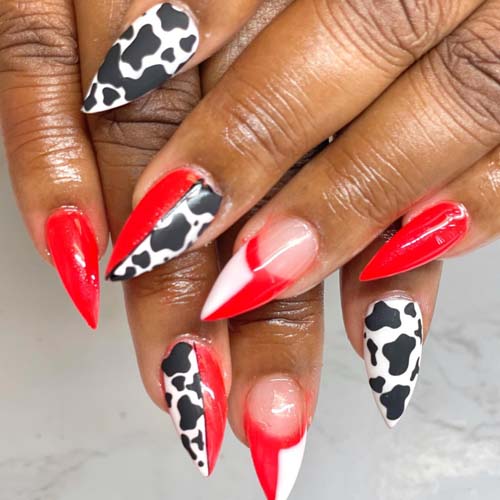 cow print, red, white, and black nail design