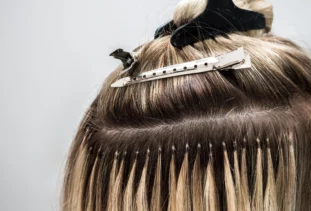 person with a row of sew-in hair extensions