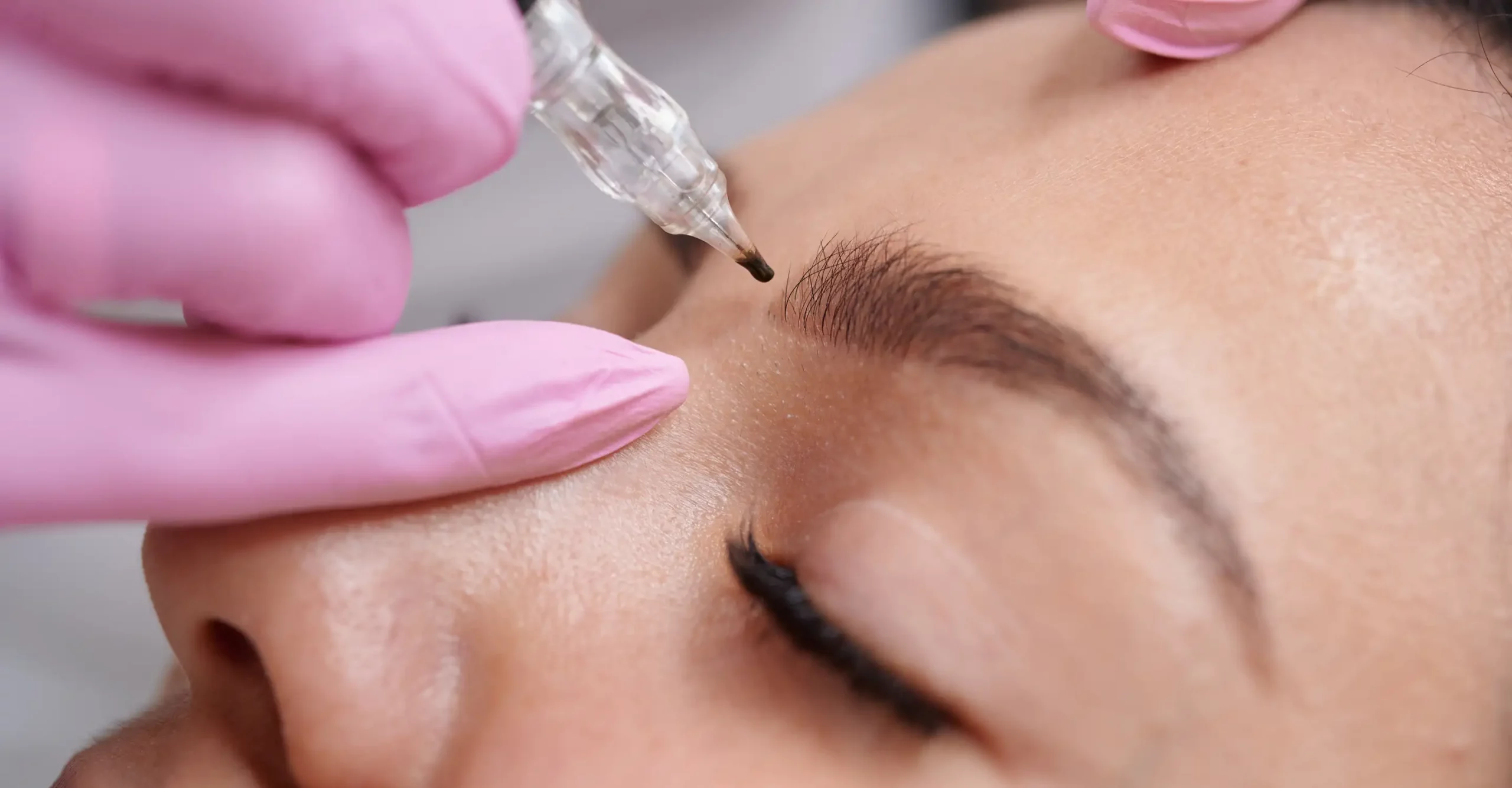 Image shows esthetician performing microshading on a client.