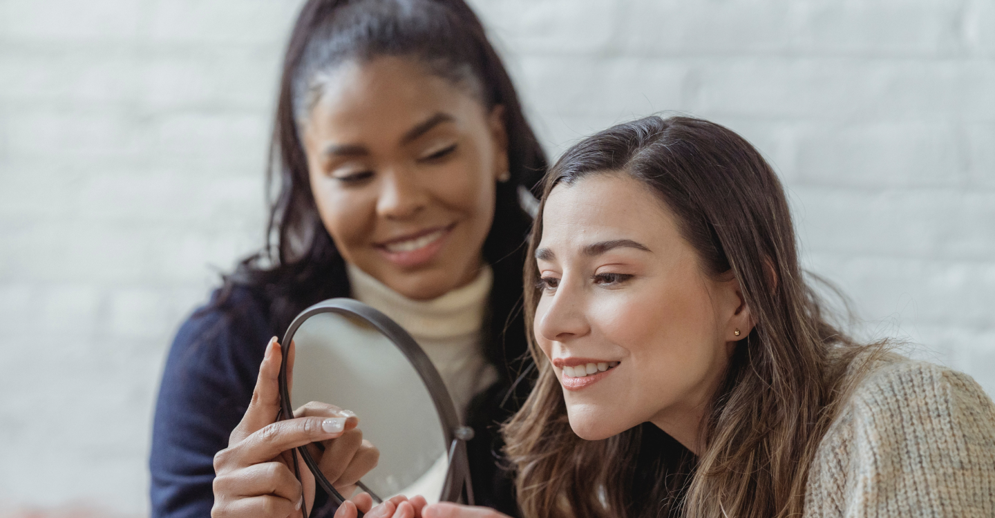 makeup artist showing client a mirror