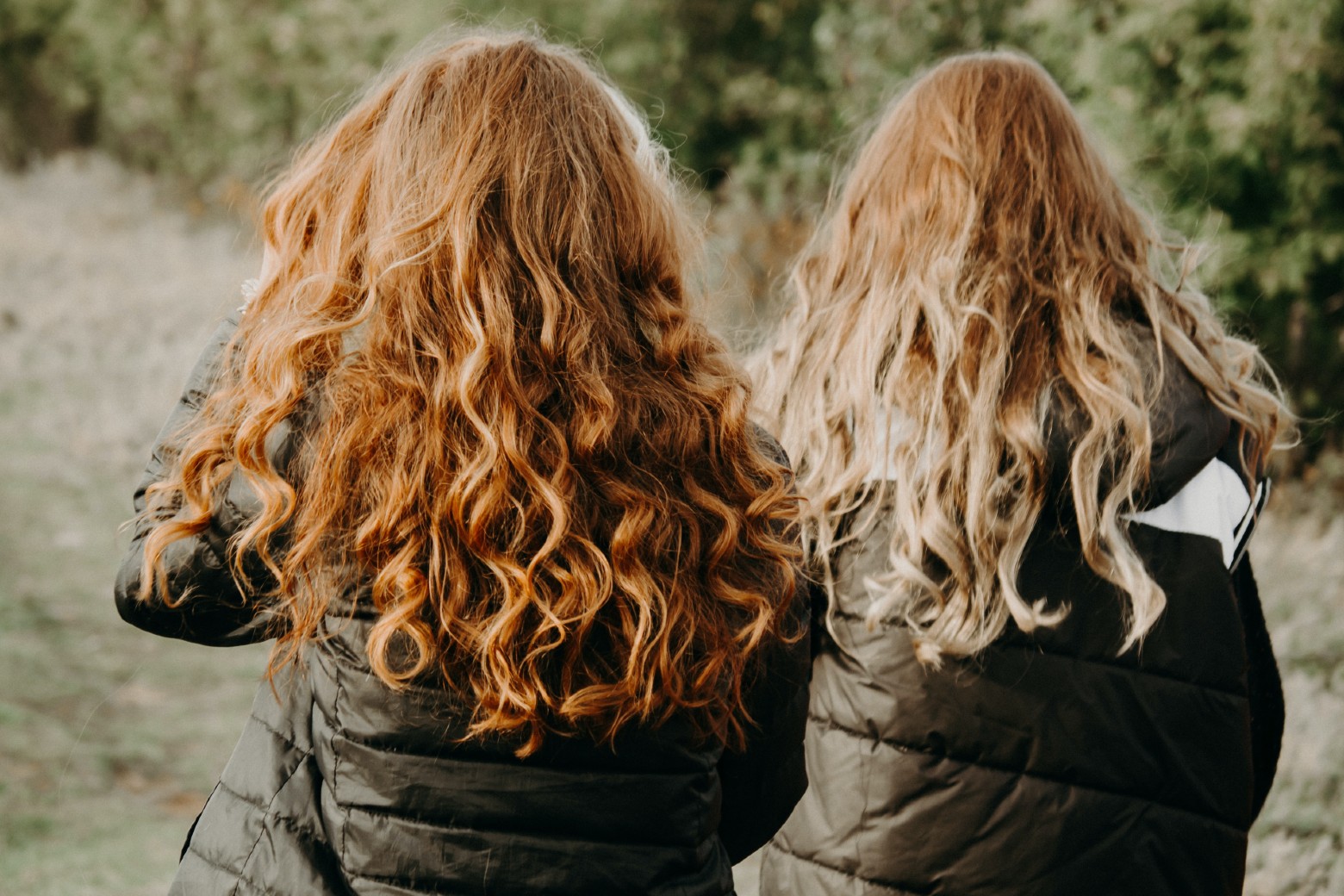 back view of two women with wavy hair