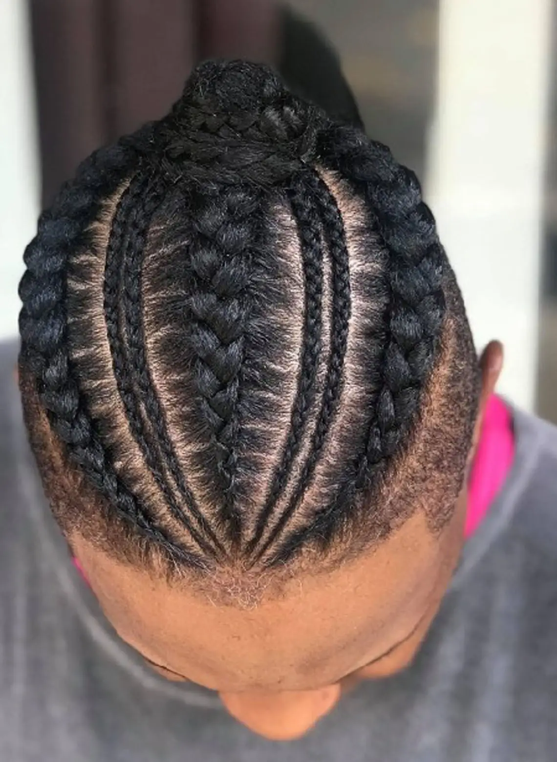 man with mixed-size cornrows. 