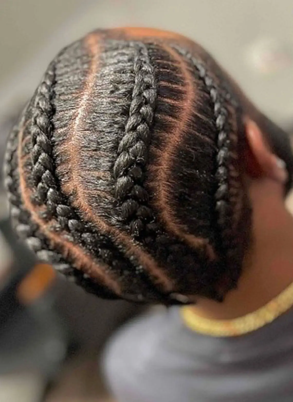 man with wavy part cornrows. 