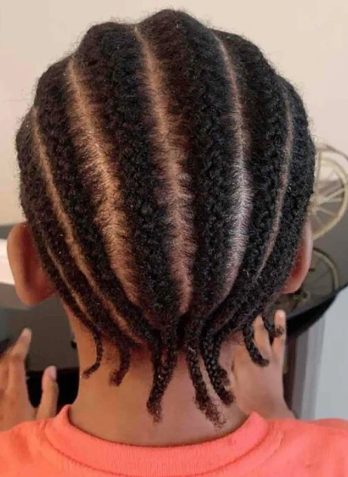 Man with braided over cornrows. 