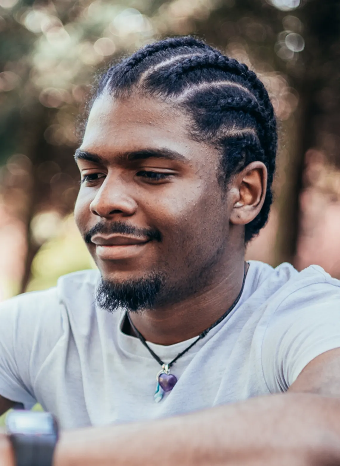 Man with straight back cornrows medium hairstyle. 