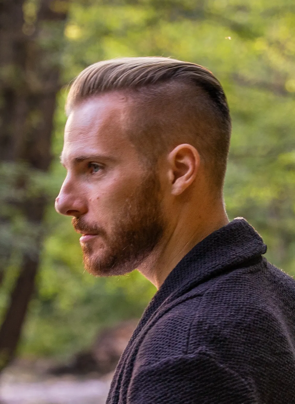 Man with asymmetrical shaved side hairstyle. 