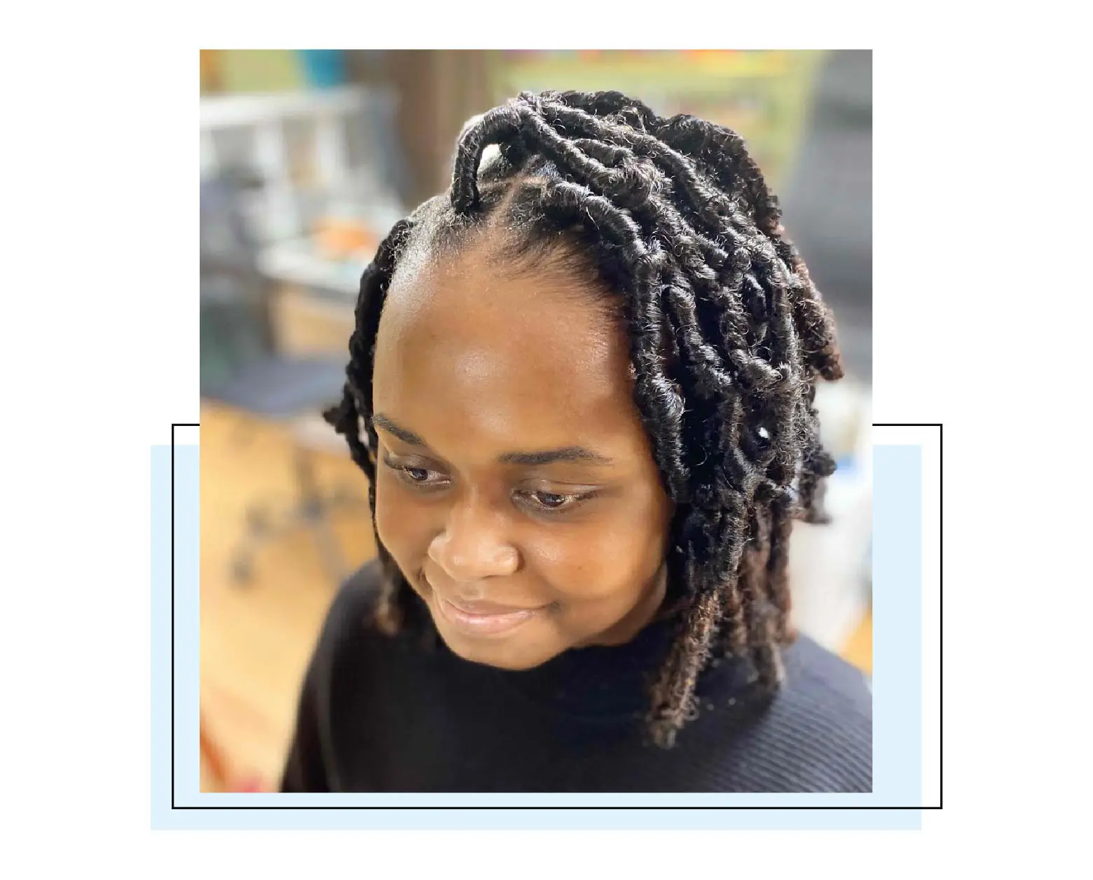 Woman with short soft locs.