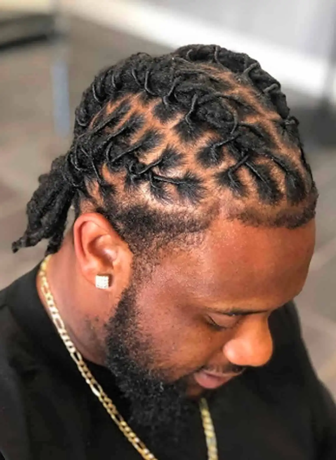Image of man with basket weave locs. 