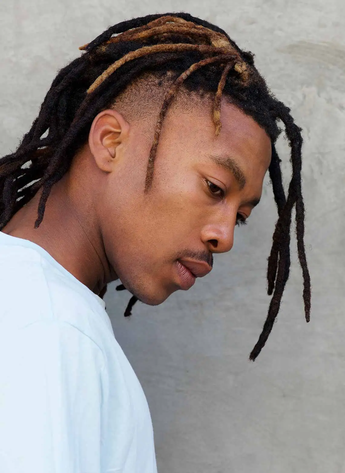 Image of man with locs and an undercut.