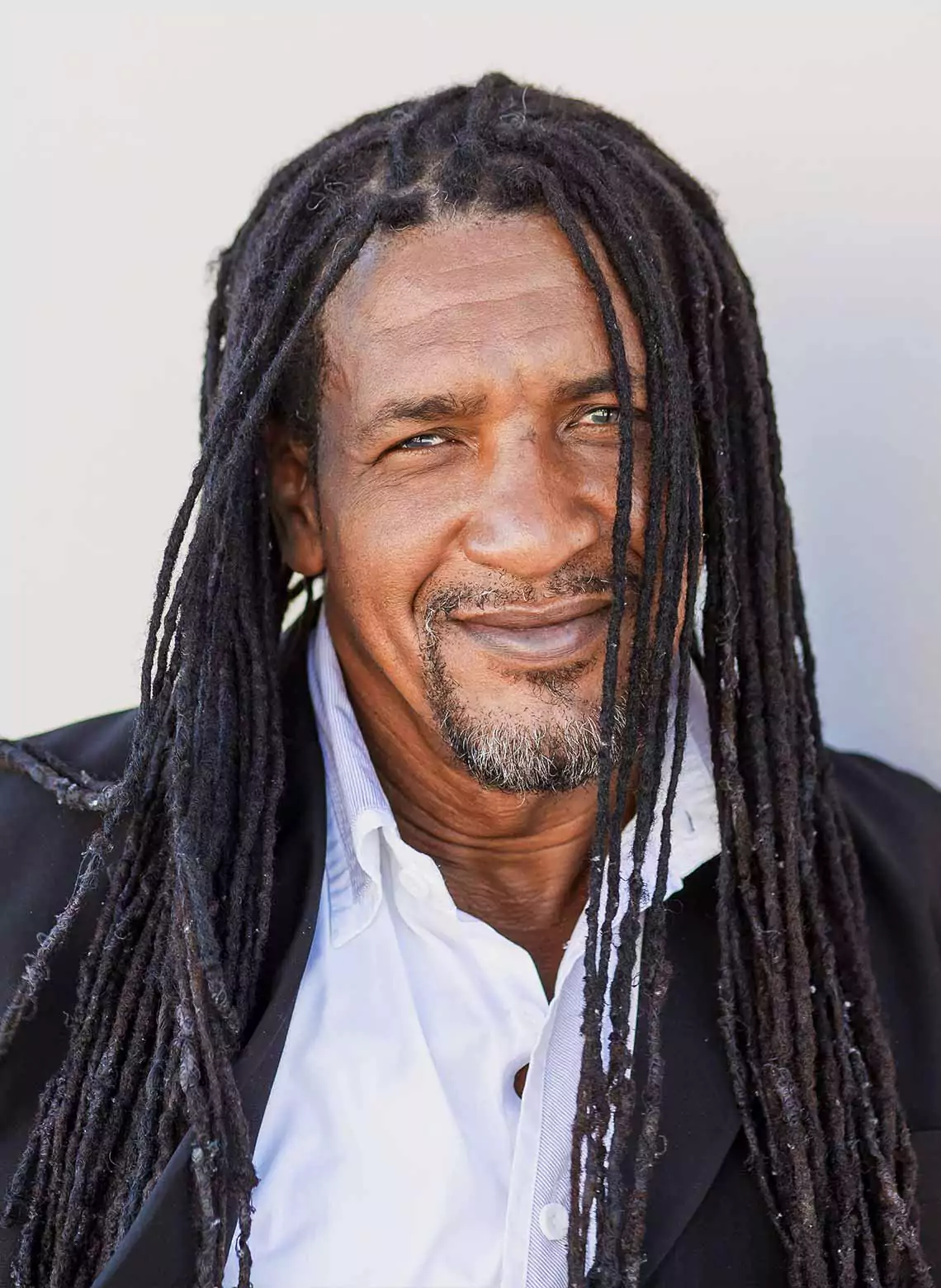 Image of man with thin locs.  