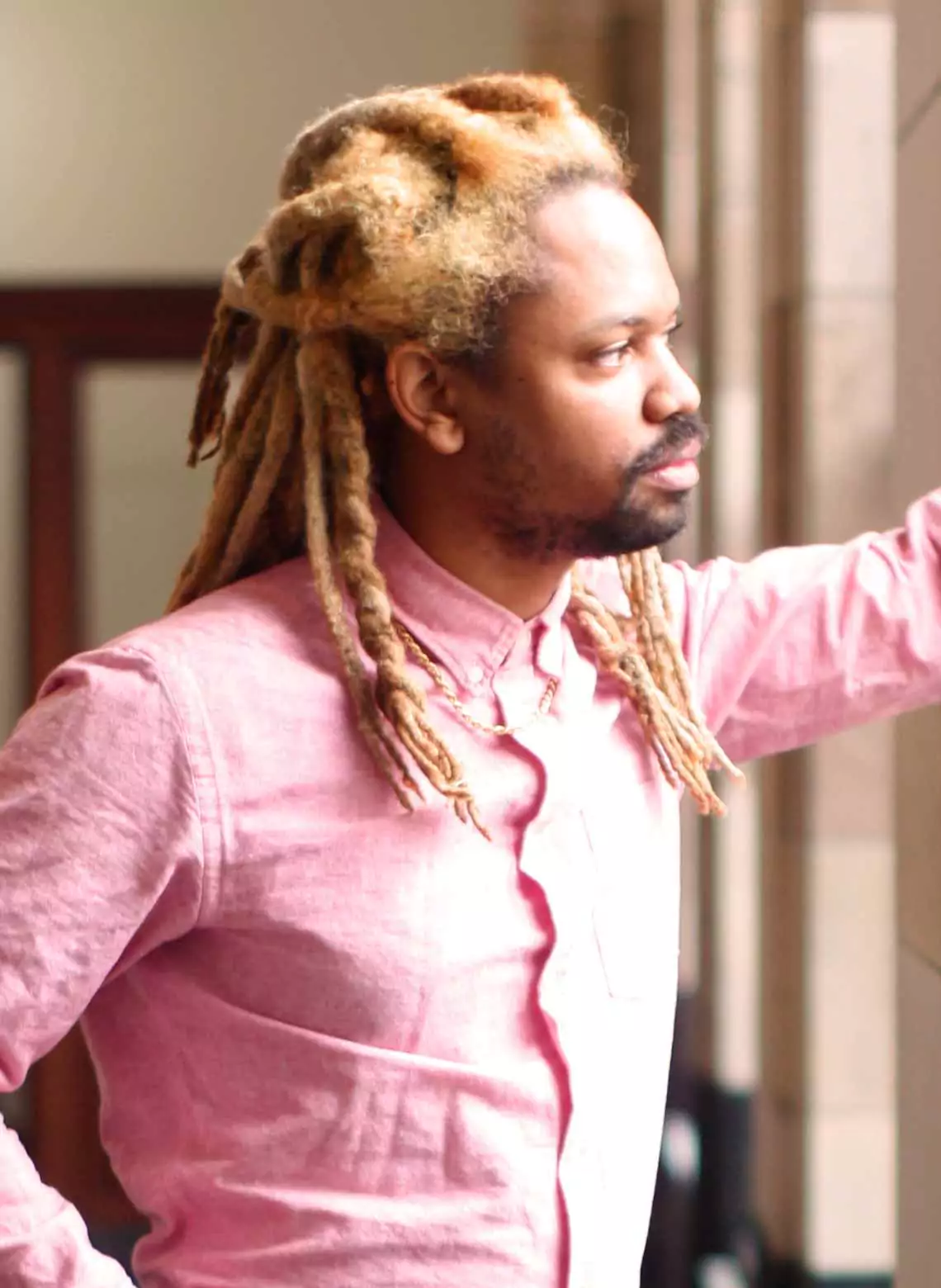 Image of man with blonde locs. 