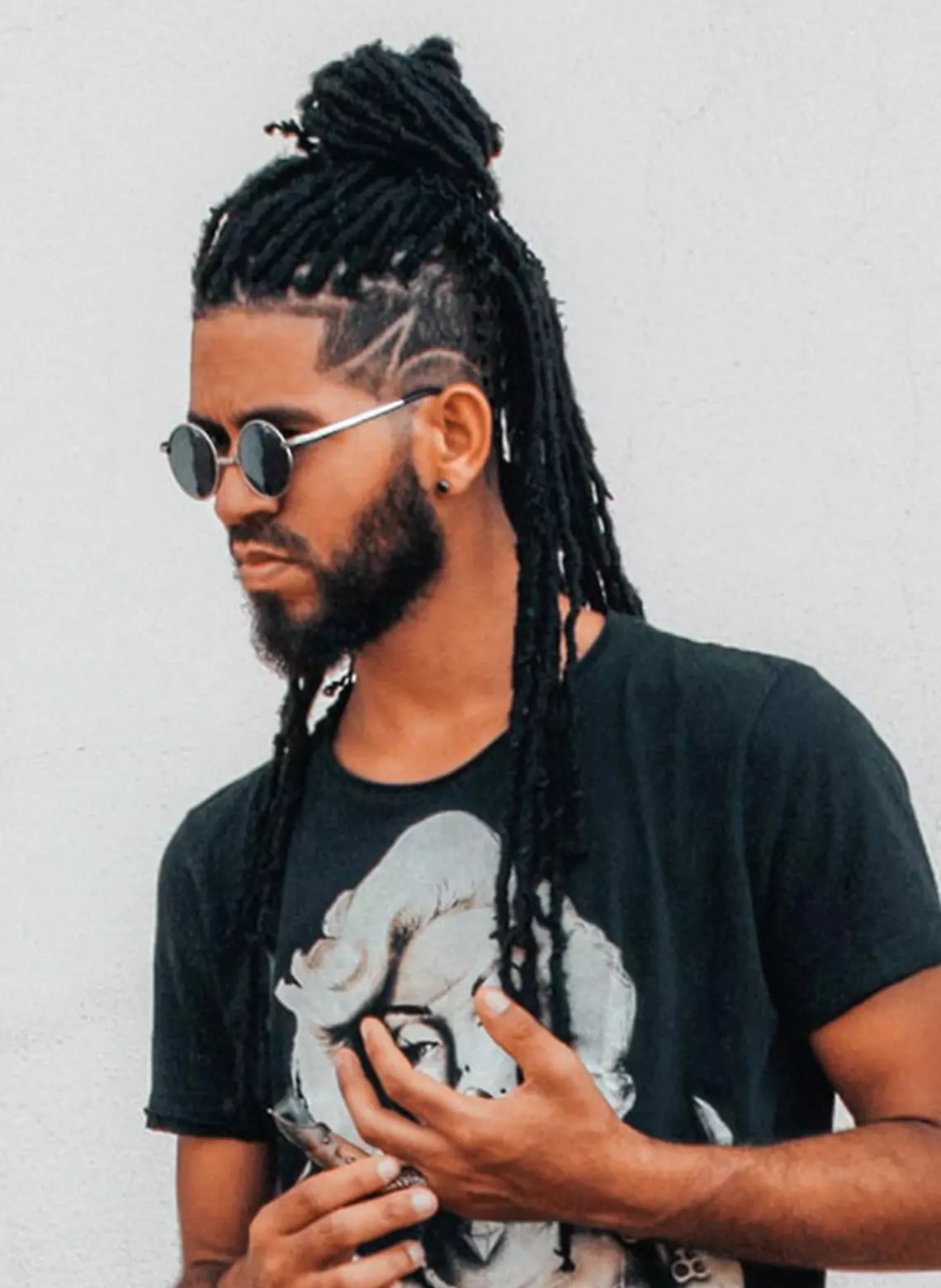 Image of man with locs and a line-up. 