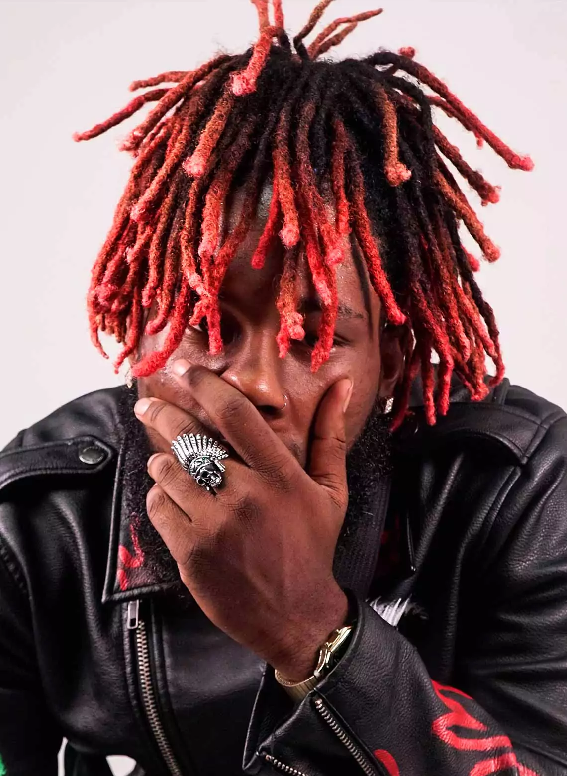 Image of man with red locs. 