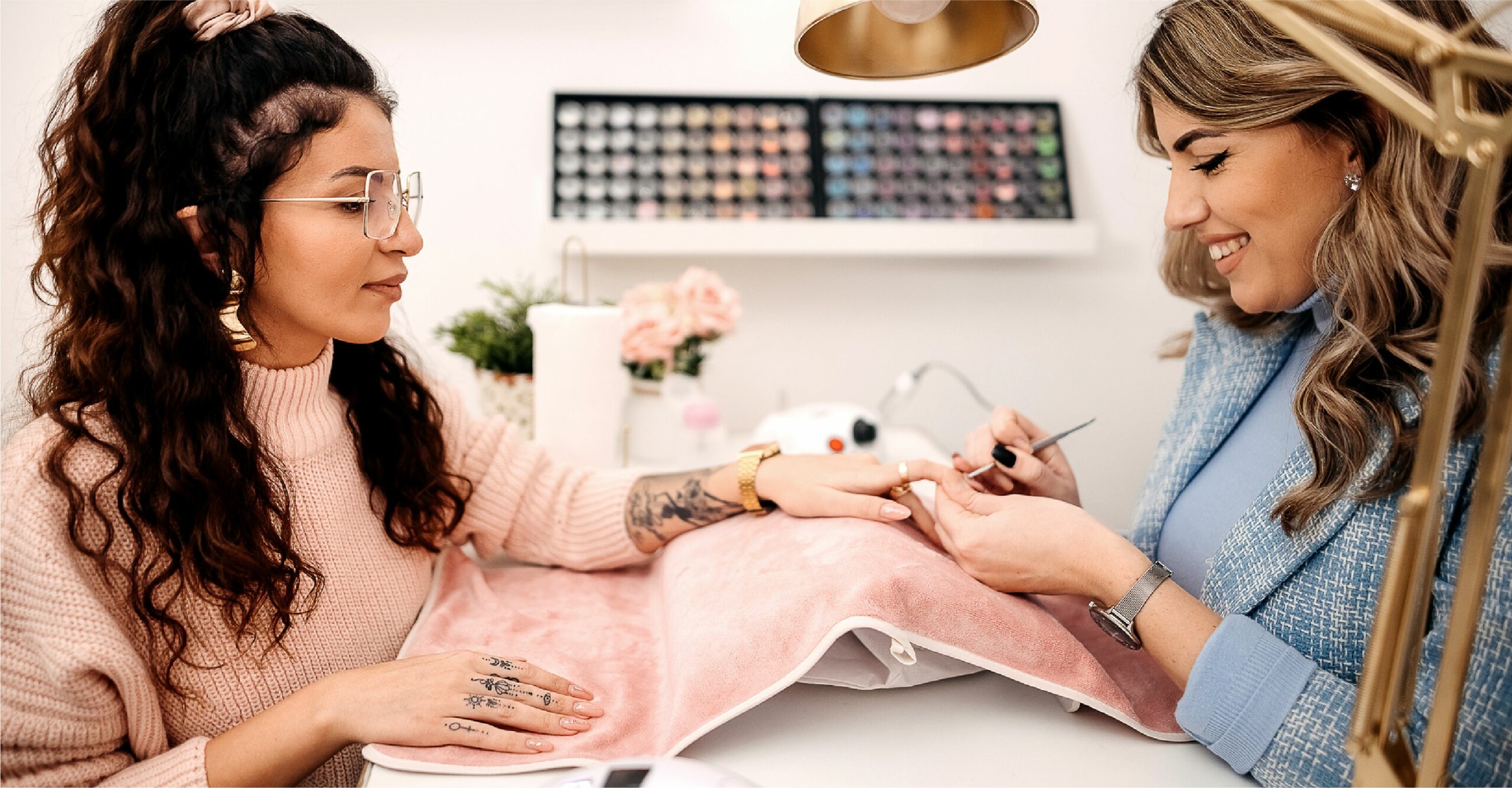 Woman gets her nails painted at salon
