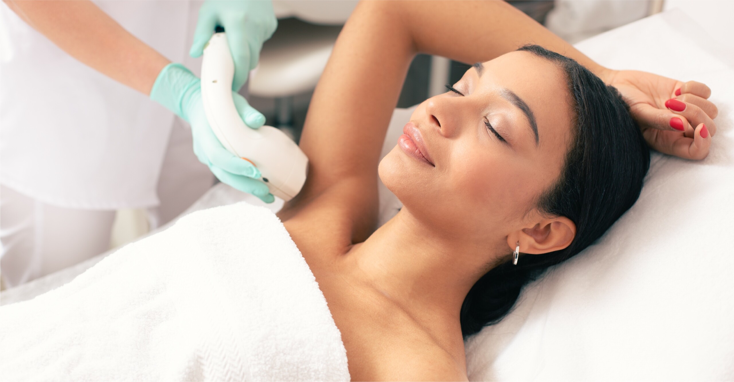 Woman is getting permanent laser hair removal on her underarms.